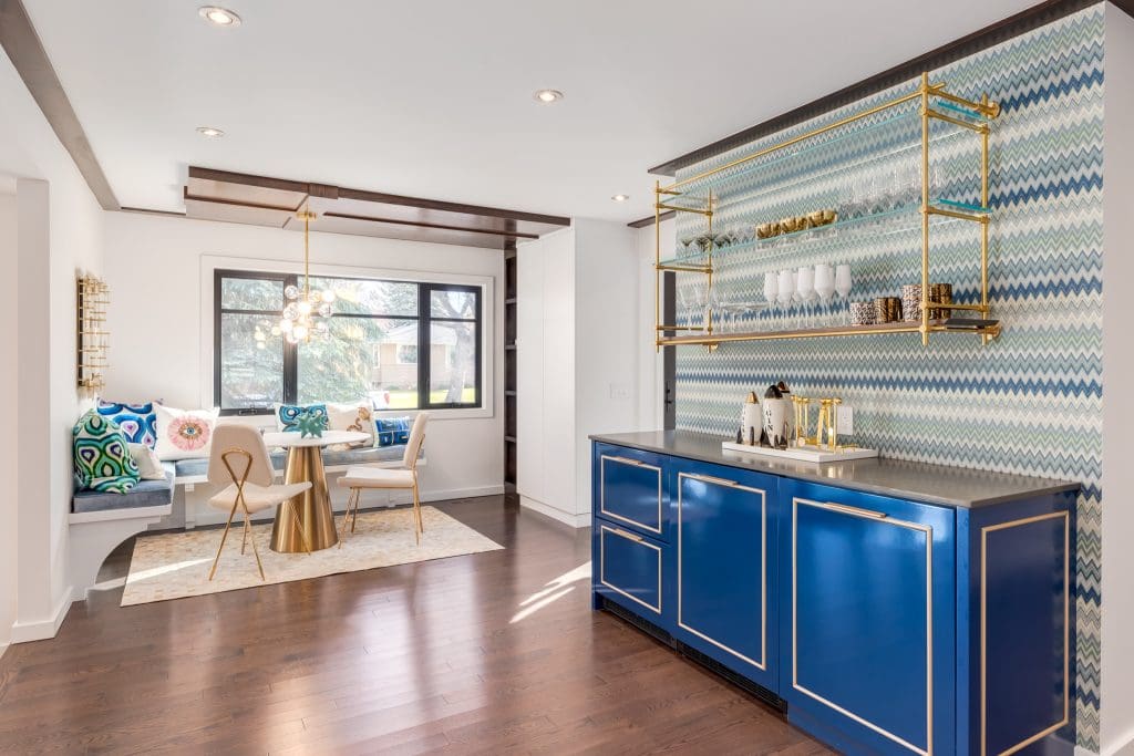 Accent bar wall with Custom built in fridge with blue doors and metal hardware and kitchen nook