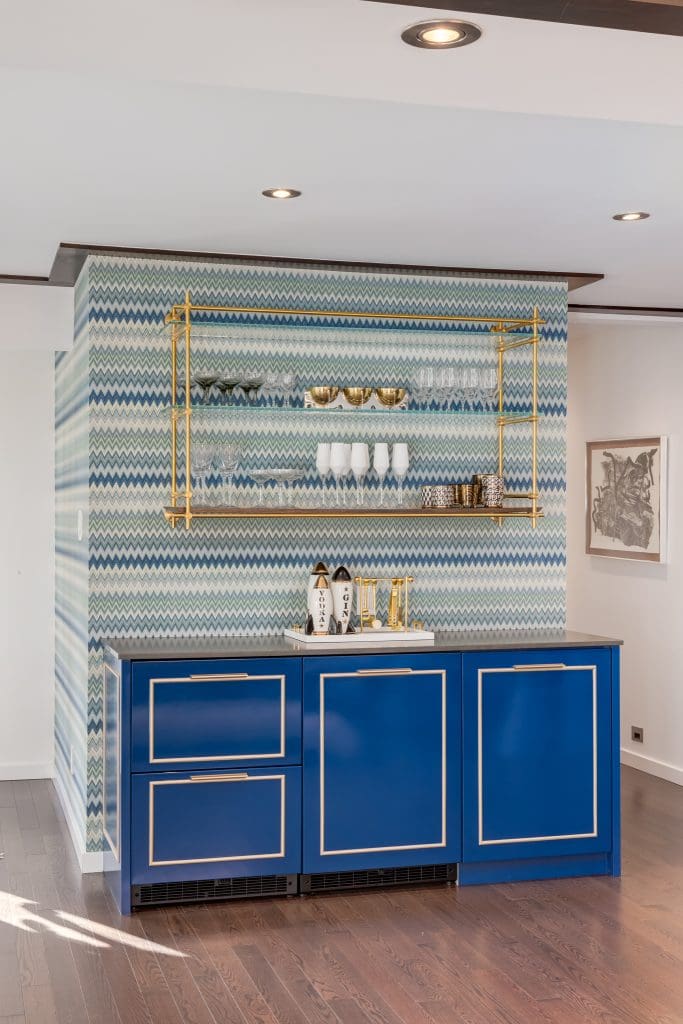 Accent bar wall with Custom built in fridge with blue doors and metal hardware