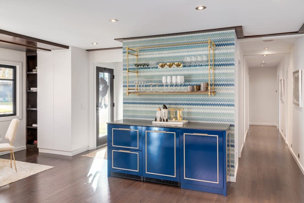 Accent bar wall with Custom built in fridge with blue doors and metal hardware