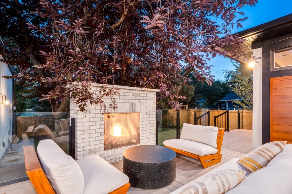 Exterior backyard patio with large stone fireplace