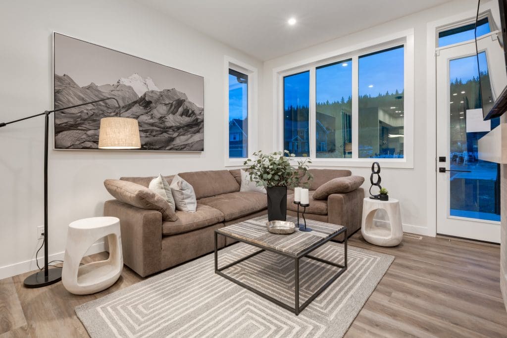 Living Room with corner windows looking onto a treed hill